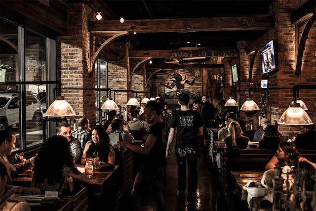 a group of people sitting at tables in a restaurant